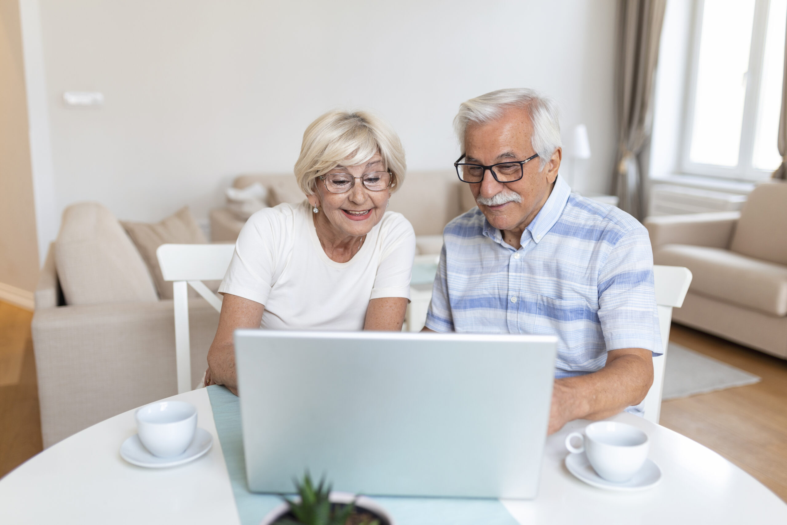 Senior couple is talking online via video connection on the laptop. Having nice time withfriends and family via video call. Senior couple is talking online via video connection on the laptop. Having nice time withfriends and family via video call.